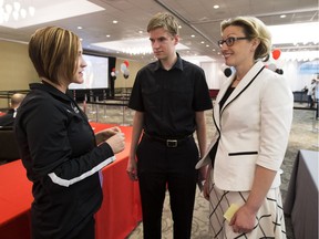 Celia Koehler, left, the Human Resources Manager, Food and Beverage at Rogers Place, talks to Trevor Horan and his instructor from NorQuest College, Tara Thompson during a job fair for Rogers Place on May 15, 2016 .