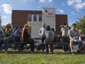 Evacuees from the Fort McMurray wildfire wait outside the Red Cross building in downtown Edmonton on May 11, 2016.