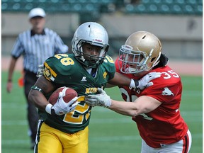 Team North's Fabeian Johnson, of Austin O'Brien, tries to outrun Notre Dame's Colton Burr the last time Commonwealth Stadium hosted Football Alberta's Senior Bowl in 2014. (File)