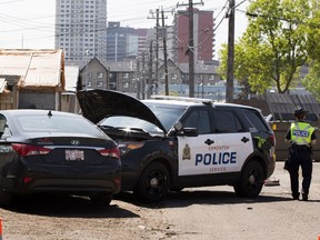 Police investigate a crash Sunday between a police vehicle and a car in the back alley  near 107 Avenue and 104 Street.