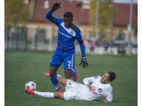 Allan Zebie of FC Edmonton, is tackled by David Diosa of the New York Cosmos at Clarke Stadium in Edmonton in September 2015.