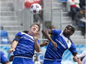 FC Edmonton captain Albert Watson ,left, heads the ball ahead of Carolina Railhawks' Kareem Moses at Clarke Park on August 16, 2015. (File)