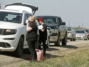 Evacuees from Fort McMurray flee south on Highway 63 after fleeing the wildfire. Some had to abandon their vehicles afte running out of gas.