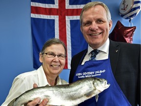 Ocean Odyssey Inland Fish Company owner Pat Batten holds an Icelandic Arctic char with Iceland MP Jon Gunnarsson as they celebrate the opening of Ocean Odyssey's new shop in west Edmonton.