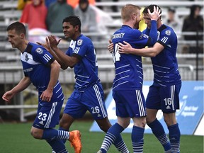 FC Edmonton Daryl Fordyce (16) celebrates with Adam Eckersley (44) after scoring on a penalty kick against the Carolina RailHawks which turned out to be the winning goal during NASL at Clarke Field in Edmonton, May 22, 2016.