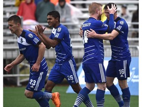 FC Edmonton Daryl Fordyce (16) celebrates with Adam Eckersley (44) after scoring on a penalty kick against the Carolina RailHawks at Clarke Field in Edmonton on May 22, 2016.