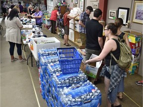 Volunteers sort through donation sat the Edmonton Emergency Relief Services, which is co-ordinating donation efforts for the Fort McMurray evacuees, in downtown Edmonton, May 4, 2016. Donations of diapers, baby wipes and toiletries are needed.