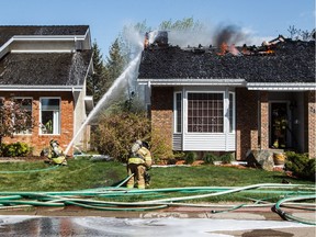 A home at 212 Wolf Ridge Close burns in Edmonton, Alta., on Sunday, May 8, 2016.