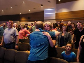 Evacuees from Fort McMurray take in a church service at the Beulah Alliance Church in Edmonton, Alta., on Sunday, May 8, 2016.