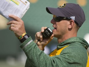 Edmonton Eskimos head coach Jason Maas delivers instructions through a speaker during training camp at Commonwealth Stadium in Edmonton Alta. on Tuesday May 31, 2016.