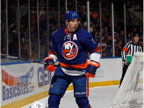 UNIONDALE, NY - FEBRUARY 10: Travis Hamonic #3 of the New York Islanders hits Jordan Eberle #14 of the Edmonton Oilers during the third period at the Nassau Veterans Memorial Coliseum on February 10, 2015 in Uniondale, New York.  The Islanders defeated the Oilers 3-2.