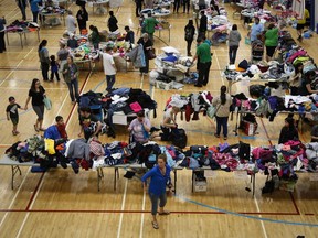 Evacuees from the Fort McMurray wildfires collect donated necessities at the evacuation centre in Lac la Biche, Alta., Thursday, May 5, 2016.