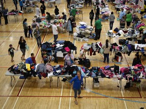 Evacuees from the Fort McMurray wildfires collect donated necessities at the evacuation centre in Lac la Biche, Thursday, May 5, 2016.