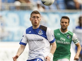 Edmonton's Jason Plumhoff (19) chases a ball as New York's Ayoze Garcia Perez (17) runs in during a NASL soccer game between FC Edmonton and the New York Cosmos at Clarke Stadium in Edmonton, Alta., on Sunday May 15, 2016. Photo by Ian Kucerak