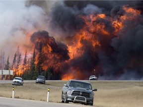 In this May 7, 2016 file photo, a wildfire burns south of Fort McMurray, Alberta.