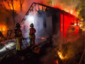 Firefighters battle a two-house blaze on University Avenue early Friday morning.