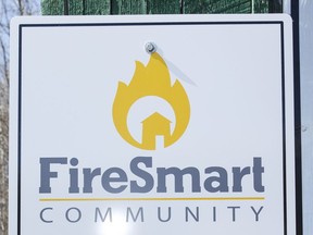 A FireSmart Community sign is seen in the hamlet of Marten Beach near Slave Lake, Alta., on Wednesday April 27, 2016.  After the 2011 Slave Lake fire, communities received funding to take fire-prevention steps across the region.