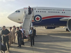 Members of Team Canada 2016 deboard the plane in Kuwait, the first of three stops over seven days. (Supplied)