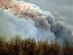 A plume of smoke from the wildfire near Fort McMurray is lit up at sunset on May 4, 2016.