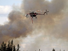 A helicopter battles a wildfire south of Fort McMurray on May 8, 2016.