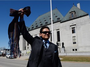 Gabriel Daniels, son of the late Harry Daniels, reacts as he leaves the Supreme Court of Canada in Ottawa on Thursday, April 14, 2016, following a unanimous ruling that Metis and non-status Indians are Indians under the Constitution.