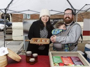 Honest Dumplings owners Ray Ma (left) and Chris Lerohl spend quality time at the farmers' market with their eight-month-old, Darwin.