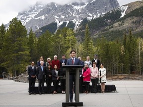 Prime Minister Justin Trudeau, centre, speaks to the media with his cabinet following the Liberal Party cabinet retreat in Kananaskis on April 26.