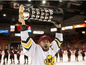 Alberta Golden Bears captain Kruise Reddick lifts the University Cup after defeating the UNB Varsity Reds 6-3 to win the Canadian Interuniversity Sports hockey championship in Halifax on Sunday, March 15, 2015.