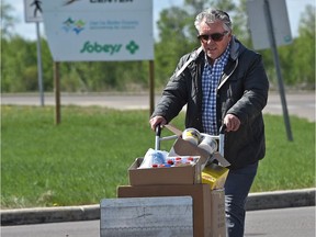 Alan Davies longtime Fort McMurray resident forced out by the wildfire last week, loading up with supplies outside the evacuation centre, at the Bold Centre in Lac La Biche, on May 10, 2016.