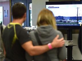 Evacuees in Lac la Biche watch a news broadcast of a tour of Fort McMurray on May 9, 2016.