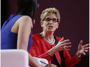 Ontario Premier Kathleen Wynne, right, speaks to Liz Plank onstage at the 2016 Liberal Biennial Convention in Winnipeg, Saturday, May 28, 2016.