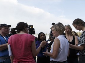 Premier Rachel Notley speaks with the media outside the evacuation centre in Anzac on May 4, 2016, after Fort McMurray was forced to evacuate because of an out-of-control wildfire.