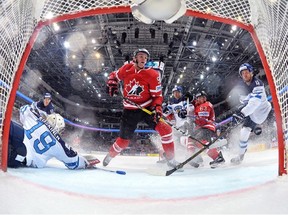 MOSCOW, RUSSIA - MAY 22: Canada's Connor McDavid #97 gets the puck past Finland's Mikko Koskinen #19 to score a first period goal with Brad Marchand #63, Jarno Koskiranta #40 and Tommi Kivisto #4 looking on during gold medal game action at the 2016 IIHF Ice Hockey World Championship.