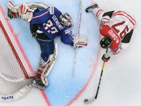Canada's Connor McDavid (R) vies with French goalie Ronan Quemener during the group B preliminary round game Canada versus France at the 2016 IIHF Ice Hockey World Championship in Saint Petersburg on May 16, 2016.