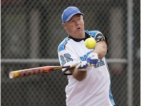 Kevin Moodie takes part in a slo-pitch game at Meadowview Park in St. Albert, Alta., on May 18, 2016. Edmonton and area slo-pitch leagues have delayed starting the 2017 season because of wet conditions.