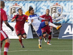 Edmonton's Dustin Corea (11) juggles the ball as Ottawa defenders pull in during a NASL game between FC Edmonton and the Ottawa Fury at Clarke Stadium in Edmonton, Alta., on Wednesday May 11, 2016.