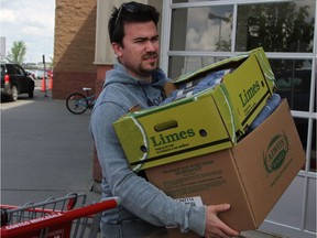 Olivier Naud carries supplies to a truck outside the Costco Wholesale in Sherwood Park on Tuesday, May 31, 2016. Residents of the Wood Buffalo region flocked to stores throughout Edmonton and the surrounding area in anticipation of re-entering Fort McMurray this week.