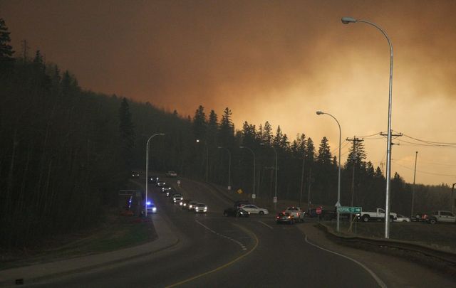 Residents of the subdivision of Abasand wait in their cars to leave the subdivision in Fort McMurray Alta. on Tuesday May 3, 2016.