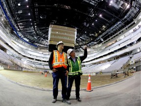 Edmonton Arena Corp. executive vice-president Bob Black (left)  and Rick Daviss, City of Edmonton executive director of the arena project, look at the interior of Rogers Place during a tour on Sunday, May 29, 2016.