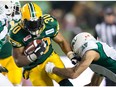 John White of the Edmonton Eskimos runs with the ball in the CFL Western Semi-Final game between the Saskatchewan Roughriders and Edmonton Eskimos at Commonwealth Stadium on November 16, 2014 in Edmonton.