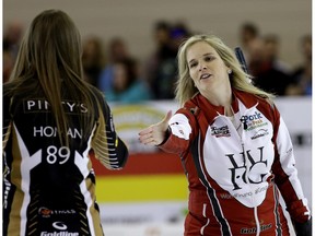 SHERWOOD PARK, ALBERTA: MAY 1, 2016 - Jennifer Jones (right/skip) reaches out to shake hands with Rachel Homan (left) after defeating Team Homan at the Grand Slam of Curling's Champions Cup women's final held at the Sherwood Park Arena on May 1, 2016. (PHOTO BY LARRY WONG/POSTMEDIA NETWORK)