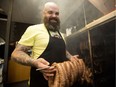 Mark Bellows owner/operator at The Local Omivore, 10933 120 St., in Edmonton, poses for a photo with smoked Hungarian sausage on May 19, 2016.