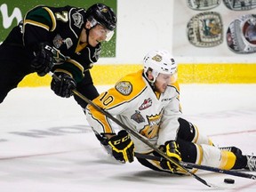 London Knights' Matthew Tkachuk, left, goes after the puck with Brandon Wheat Kings' Kale Clague during third period CHL Memorial Cup hockey action in Red Deer, Monday, May 23, 2016.