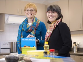 Human nutrition professors Rhonda Bell, left, and Catherine Chan, right, received their University of Alberta Community Connections award for developing the Pure Prairie Eating Plan at a city hall ceremony Monday morning.