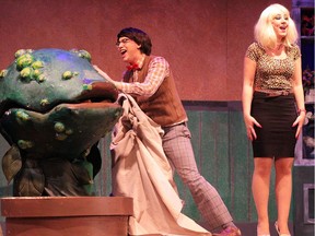 Malik Hinton, centre, and Hailee Elkow (with Bethany Urban puppeteering and Sam Brown Weasel doing the voice of Audrey II) in the Eastglen production of Little Shop of Horrors.