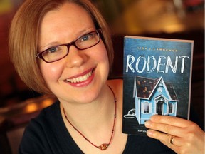 Edmonton author Lisa J. Lawrence holds up a copy of her young adult novel Rodent, about a high school girl struggling to hold her life together in the tumultuous wake of her alcoholic mother. Photo by Fish Griwkowsky