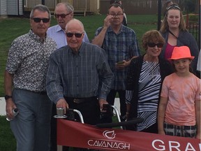 Former Edmonton mayor Terry Cavanagh (with walker) poses with Coun. Bryan Anderson (left) and family members Sunday, May 29, 2016, at the ribbon-cutting for the new neighbourhood named for him.