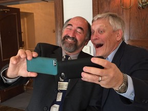 California State University Prof. Larry Rosen (left) and Boston pediatrician Dr. Michael Rich (right) are in Edmonton May 26, 2016, to give presentations about the health effects of using technology. Here, they take selfies with their cellphones.