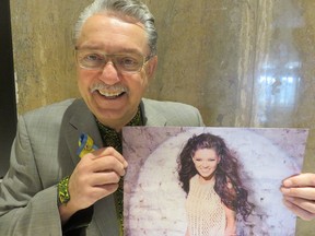 Gene Zwozdesky holds a photo of Ukraine's Ruslana, a pianist, symphony conductor, former MP and Eurovision Song Contest winner who has accepted an invite to perform, serve as key-note speaker and education presenter during celebrations in August to mark Ukraine's 25th anniversary of its independence.