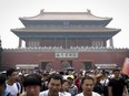 Visitors leave the Forbidden City during the May Day holiday in Beijing, Sunday, May 1, 2016.